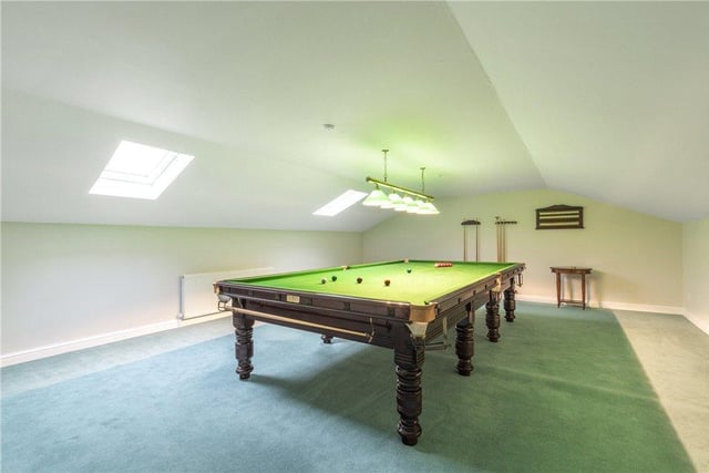 This games room above the garage includes a full-size snooker table, something many keen players dream of owning