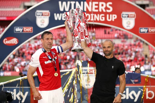 SWEET MEMORIES: Rotherham United manager Paul Warne (right) and match-winner Richard Wood pose with the trophy after the Sky Bet League One Final at Wembley Picture: John Walton/PA