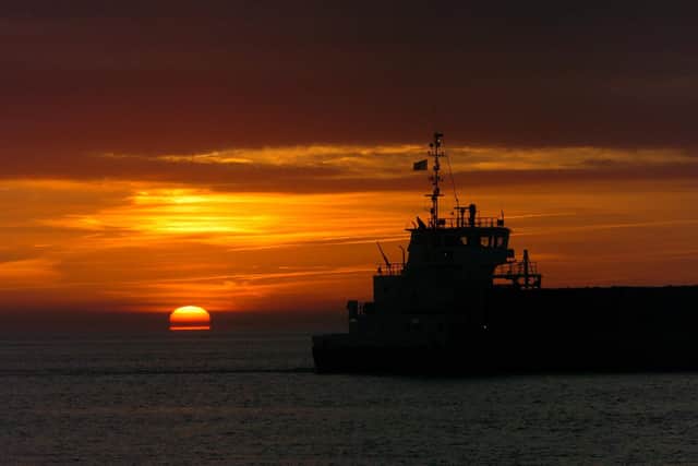 A ship makes her way up the River Humber past Hull heading for Goole or the Trent wharves as a winter sun rises out of the water. Picture: Terry Carrott