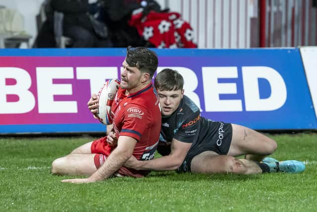 Picture by Allan McKenzie/SWpix.com - 04/03/2022 - Rugby League - Betfred Super League Round 4 - Hull KR v St Helens - Sewell Group Craven Park, Hull, England - Lachlan Coote tackled by Jack Welsby.