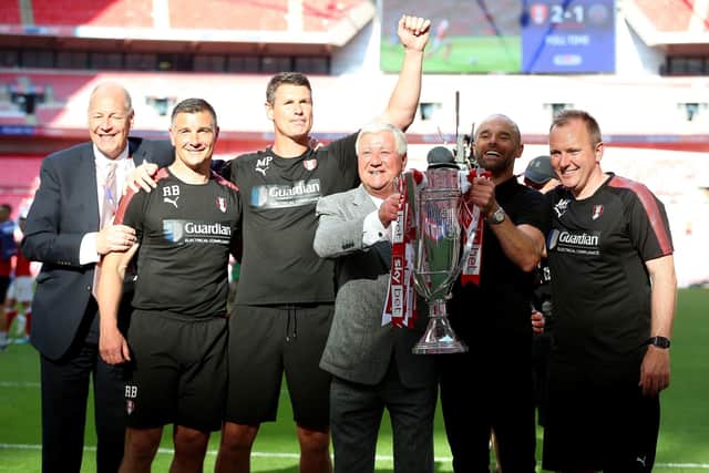 Rotherham United manager Paul Warne (second right) and chairman Tony Stewart (centre right) celebrate with the trophy and first team/development coach Matt Hamshaw (right), goalkeeping coach Mike Pollitt (centre left) and assistant manager Richie Barker (second left) after the Sky Bet League One Final at Wembley Stadium in 2018 (Picture: PA)