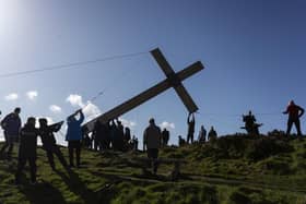 Volunteers carrying the cross up the hill