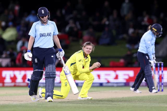Australia's Jess Jonassen, center, holds a catch to dismiss England's Kate Cross. (Martin Hunter/Photosport via AP)