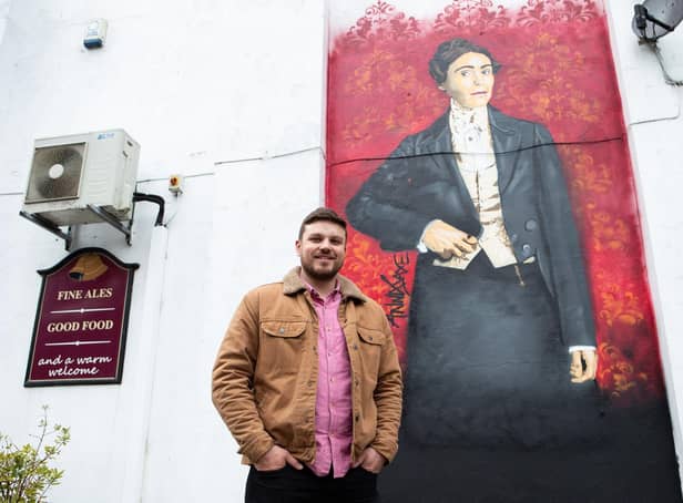 Ring O' Bells landlord David Rossiter with the Anne Lister mural by Anna Jaxe