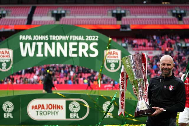 Rotherham boss Paul Warne celebrates with the EFL Trophy.