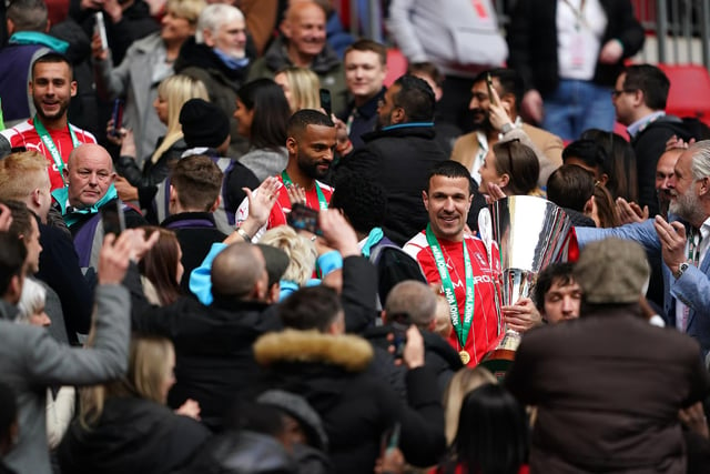 Rotherham's Richard Wood carries the Papa John's Trophy down the Wembley steps.