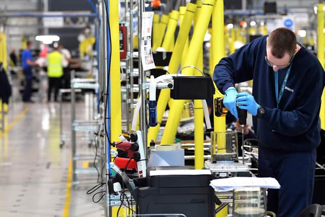 Airbus employees work on the assembly line to produce ventilators at the Advanced Manufacturing Research Centre (AMRC Cymru) in Broughton, north Wales, like the on in Rotherham. Photo by PAUL ELLIS/AFP via Getty Images.