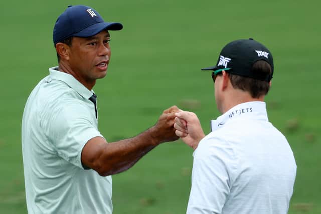 PREPARATIONS: Tiger Woods greets Zach Johnson on the range during a practice round prior to the Masters at Augusta National. Picture: Andrew Redington/Getty Images.