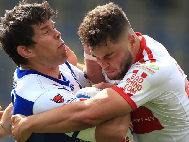 Powerhouse Hull KR pack man Matthew Storton, right in defensive mode against St Helens' Louie McCarthy-Scarsbrook, reckons back-to-back wins stands the Robins in good stead for their Challenge Cup quarter-final with Castleford Tigers. Picture: Mike Egerton/PA Wire.