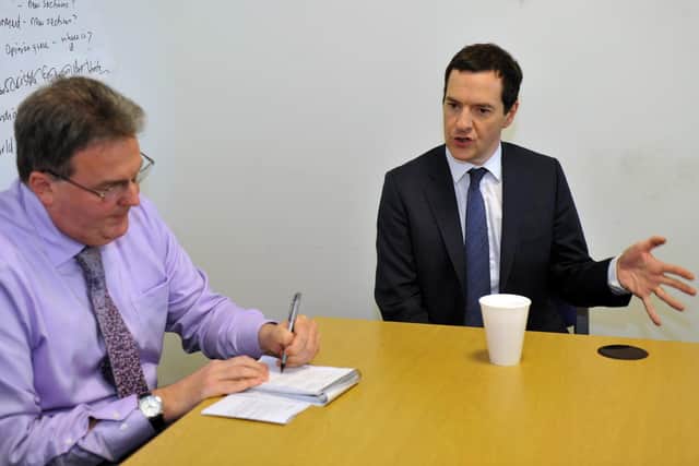 Tom taking notes as George Osborne's answers his questions.
