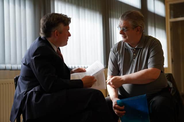 Jonathan Ashworth speaking to a man at Parson Cross Forum in Sheffield.