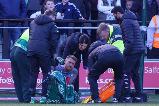 Harrogate Town goalkeeper Mark Oxley is stretchered of the pitch at Salford. Picture courtesy of Matt Kirkham.