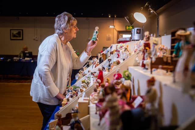 Doreen Vincent, former organizer of the Leeds Dolls House Fair, owner of Small Wonders Miniatures in Idle, Bradford, setting up her stall before the doors open to the public. Image: James Hardisty