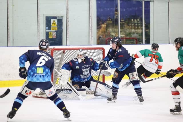 Sheffield Steeldogs' Lee Bonner battles for possession in front of the home team's net during Saturday's 2-1 defeat at Ice Sheffield to Basingstoke Bison. Picture: Peter Best