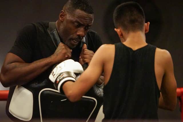 Idris Elba in the ring with one of the youngsters. Photo: PA Media/BBC/Workerbee.