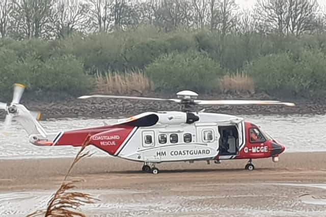 The Coastguard helicopter landed on the mud flats to evacuate the crew