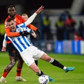 Luton Town's Fred Onyedinma gets to grips with Huddersfield Town's Harry Toffolo. Picture: PA.