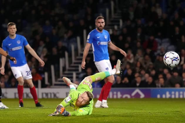 Rotherham United goalkeeper Viktor Johansson (second right) concedes the first goal from Portsmouth's Clark Robertson (right). Pcture: PA