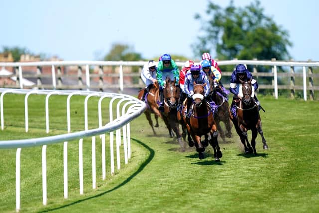 Majalaat ridden by Oliver Stammers (centre) leads before Where's Jeff ridden by Joanna Mason goes on to become the eventual winner of the Brantingham Handicap at Beverley racecourse last June (Picture: PA)