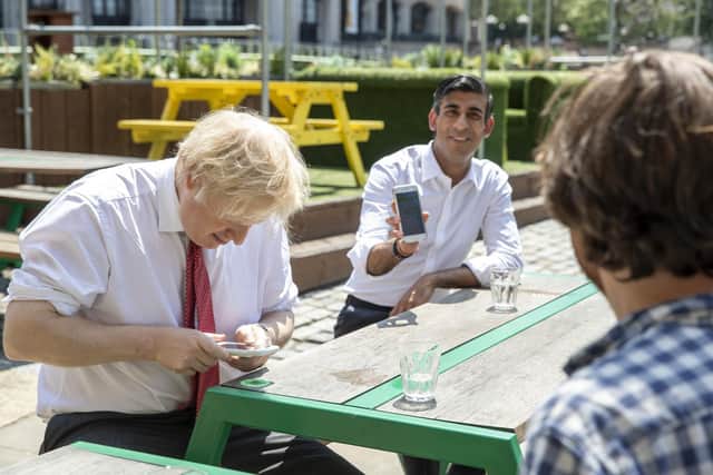 Prime Minister Boris Johnson (left) and the Chancellor of the Exchequer Rishi Sunak (centre), during a visit to the Pizza Pilgrims restaurant in east London