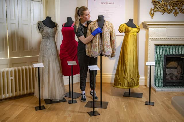 Assistant curator Sarah Davies with the Norman Hartnell 1930s gown, the 1960s pink cocktail dress, the 1920s beaded jacket and the Regency Bridgerton-style gown, all on display at Lotherton Hall's latest fashion exhibition, What Shall I Wear. Picture Tony Johnson
