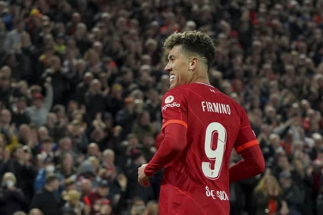Liverpool's Roberto Firmino celebrates scoring his side's second goal during the Champions League quarterfinal second leg soccer match between Liverpool and Benfica. (AP Photo/Jon Super)
