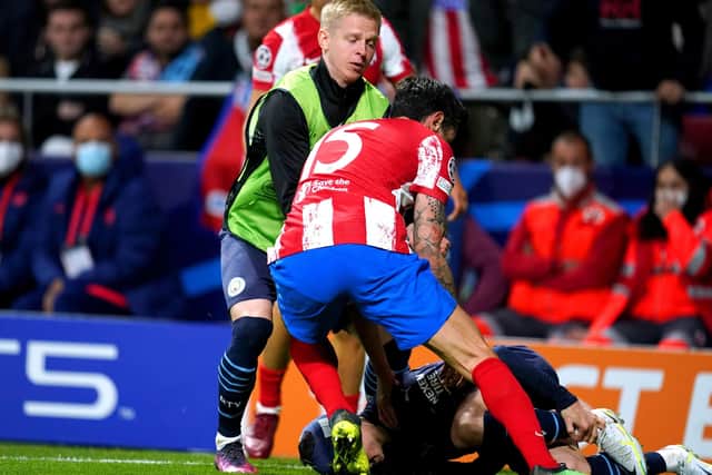 Manchester City's Oleksandr Zinchenko (left) tries to stop Atletico Madrid's Stefan Savic from dragging Phil Foden off the pitch during the UEFA Champions League quarter final (Picture: Nick Potts/PA)