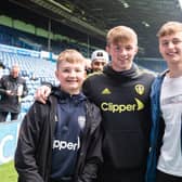 GIVING BACK: Joe Gelhardt, above centre, was one of three Leeds players who surprised 10 children and their families who had been invited to Elland Road by Yorkshire Cancer Research this week. Picture: Leeds United.
