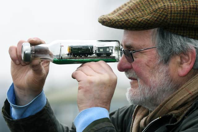 Bob Lovett with a locomotive he has made in a bottle. Picture : Jonathan Gawthorpe