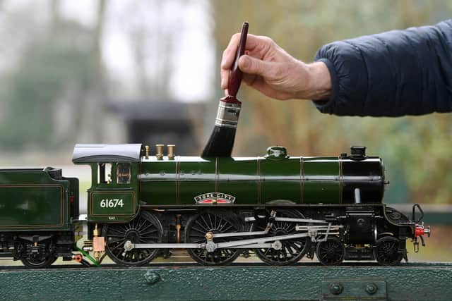 Tom Barnes with his York City model locomotive. Picture : Jonathan Gawthorpe