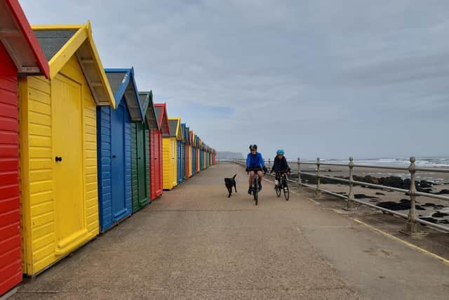 Brothers Daniel (11) and Luke (9) Shipton cycle along the sea wall at Whitby with their black Labrador dog, Frankie, ahead of the Easter holidays.