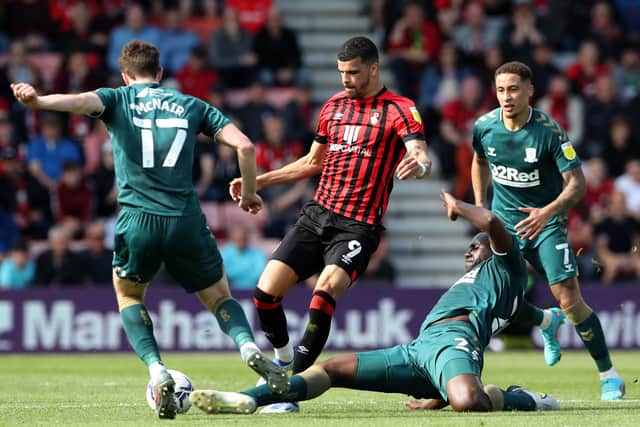 Bournemouth's Dominic Solanke hurdles a challenge from Middlesbrough's Sol Bamba. Picture: PA.