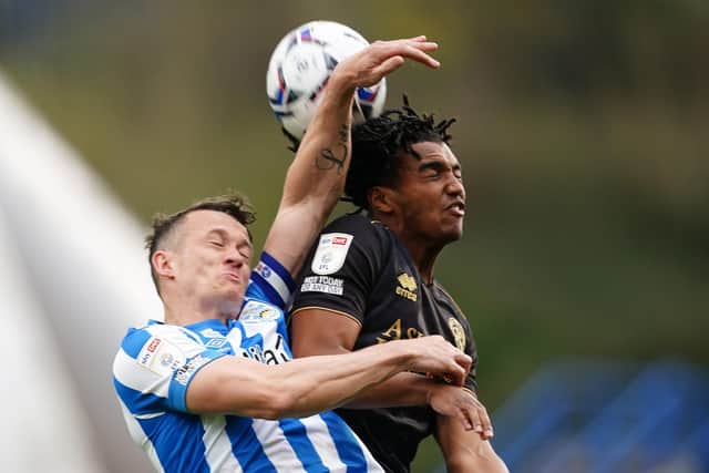 Huddersfield Town's Jonathan Hogg and Queens Park Rangers' Sam McCallum battle for the ball. Pictures: PA