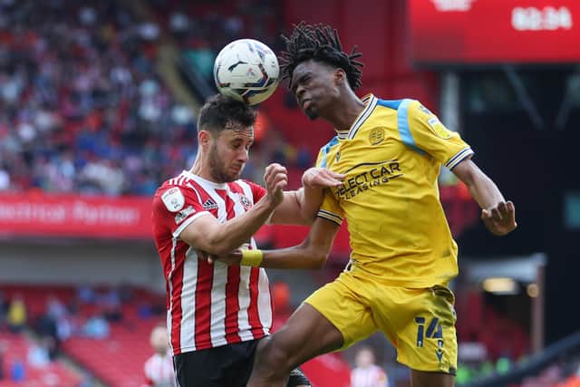 George Baldock of Sheffield Utd and Ovie Ejaria of Reading jump for the ball. Picture: Simon Bellis / Sportimage