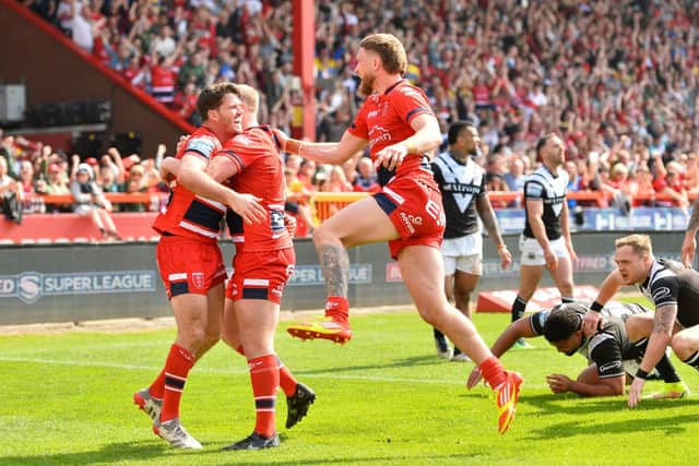 ON THE UP: Hull KR's Lachlan Coote celebrates with team-mates Jordan Abdull and Ethan Ryan after scoring a try against derby rivals Hull FC. Picture by Will Palmer/SWpix.com