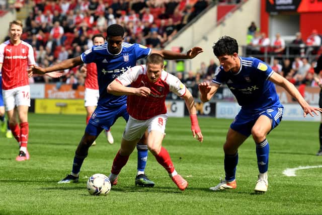 Rotherham player Ben Wiles is challenged by the Ipswich defence.