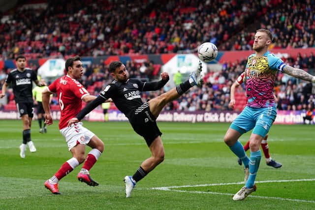 Sheffield United's George Baldock (centre) lifts the ball over the on-rushing Bristol City goalkeeper Daniel Bentley at Ashton Gate. Picture: David Davies/PA