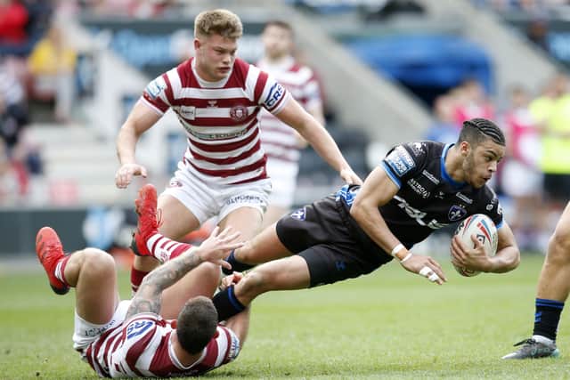 Tackled:  Wakefield Trinity's Lewis Murphy is hauled down by  Wigan Warriors' Cade Cust and Morgan Smithies. Picture by Ed Sykes/SWpix.com