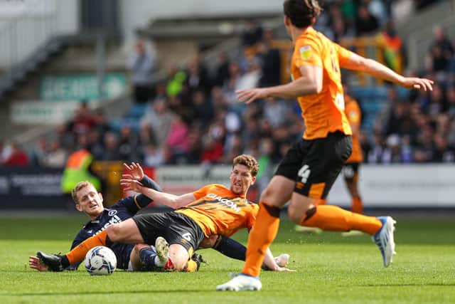 Millwall's George Saville (left) and Hull City's Richard Smallwood battle for the ball at The Den. Picture: Kieran Cleeves/PA