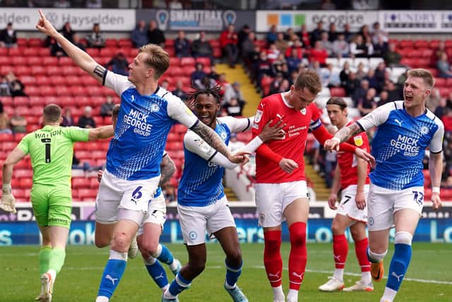 KILLER BLOW: Peterborough United's Frankie Kent celebrates scoring his side's second goal at Oakwell Picture: Martin Rickett/PA