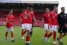 Barnsley's Romal Palmer (centre) and team-mates show their disappointment after losing to relegation rivals PEterborough United at Oakwell, Barnsley. Picture: Martin Rickett/PA