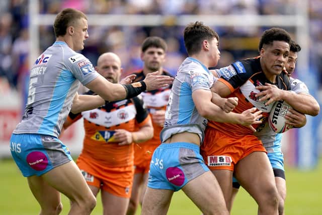 In the thick of it: Castleford Tigers' Derrell Olpherts (right) is tackled by Leeds Rhinos' Jack Sinfield during the hosts' derby win. Picture: Danny Lawson/PA Wire.