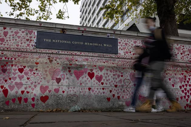 embers of the public walk past the National Covid Memorial Wall. Photo by Rob Pinney/Getty Images.