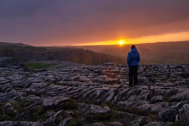 Many of our readers said it had to be Malham Cove - in fact it was the most voted for landmark. The tourist attraction, in Malham, is a huge curving amphitheatre shaped cliff formation made up of limestone rock. It is a well known beauty spot and a popular place to visit. Pictured is a walker watching the sunrise at Malham Cove on the first Bank Holiday of 2022. Taken by Bruce Rollinson.