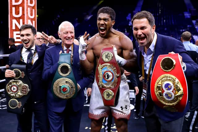 Anthony Joshua poses for a photo with the IBF, WBA, WBO & IBO World Heavyweight Title belts with Eddie Hearn and Barry Hearn after the IBF, WBA, WBO & IBO World Heavyweight Title Fight between Andy Ruiz Jr and Anthony Joshua during the Matchroom Boxing 'Clash on the Dunes' show at the Diriyah Season on December 07, 2019 (Picture: Richard Heathcote/Getty Images)