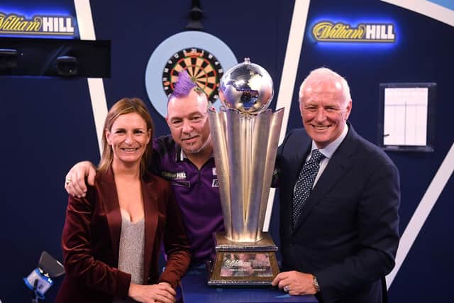 LONDON, ENGLAND - DECEMBER 31:  Peter Wright is presented the trophy by Charlotte Emery, William Hill Global Brand and Marketing Director and PDC Chairman Barry Hearn  after victory in the Final of the 2020 William Hill World Darts Championship. (Picture: Alex Davidson/Getty Images)