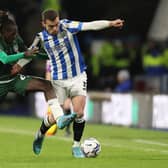 DANGEROUS: Huddersfield Town's Harry Toffolo holds of Domingos Quina of Barnsley