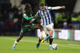 DANGEROUS: Huddersfield Town's Harry Toffolo holds of Domingos Quina of Barnsley