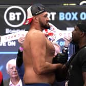 Little and large: WBC heavyweight champion Tyson Fury towers over Dillian Whyte at yesterday’s weigh-in. Picture: Nick Potts/PA