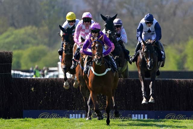 Almost there: Dreams of Home ridden by jockey Brian Hughes (centre) on their way to winning the Bob Nelson Capercaillie Handicap Chase and his 200th win of the season at Perth. Picture: Jane Barlow/PA Wire.